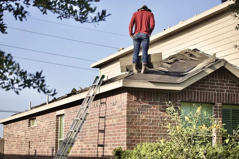 Professional roofer working on a residential roof in Rolling Green Ridge